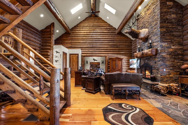 4475 Star Meadows Rd, Whitefish, MT 59937 - living room with high vaulted ceiling, rustic walls, light wood-type flooring, beam ceiling, and a fireplace