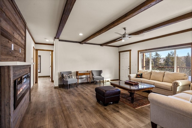 4475 Star Meadows Rd, Whitefish, MT 59937 - living room with ornamental molding, a glass covered fireplace, a ceiling fan, dark wood-style floors, and beamed ceiling