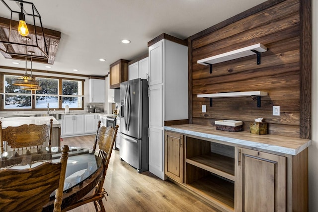 4475 Star Meadows Rd, Whitefish, MT 59937 - kitchen with stainless steel fridge with ice dispenser, light wood-style floors, recessed lighting, light countertops, and white cabinets