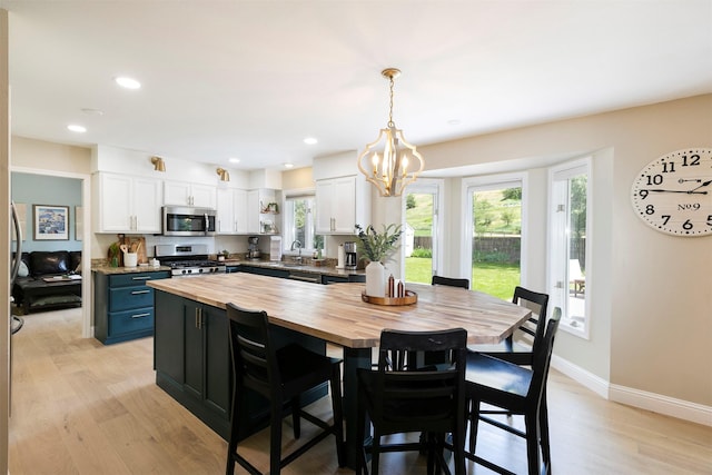 108 Apple House Ln, Missoula, MT 59802 - kitchen with butcher block counters, appliances with stainless steel finishes, white cabinetry, healthy amount of natural light, and recessed lighting