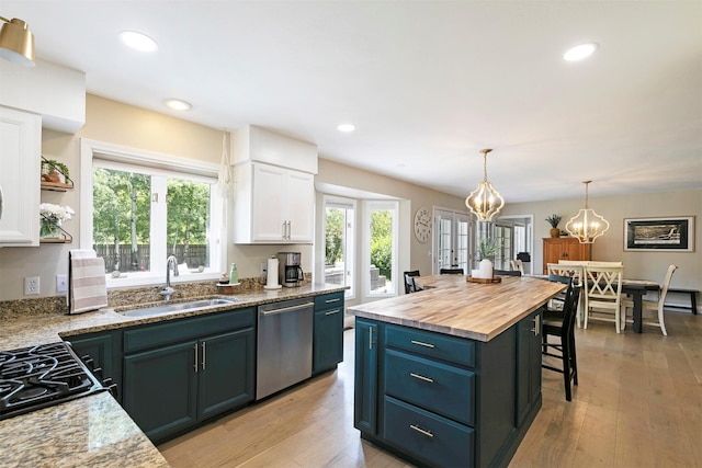 108 Apple House Ln, Missoula, MT 59802 - kitchen featuring stainless steel dishwasher, white cabinetry, healthy amount of natural light, butcher block countertops, and recessed lighting