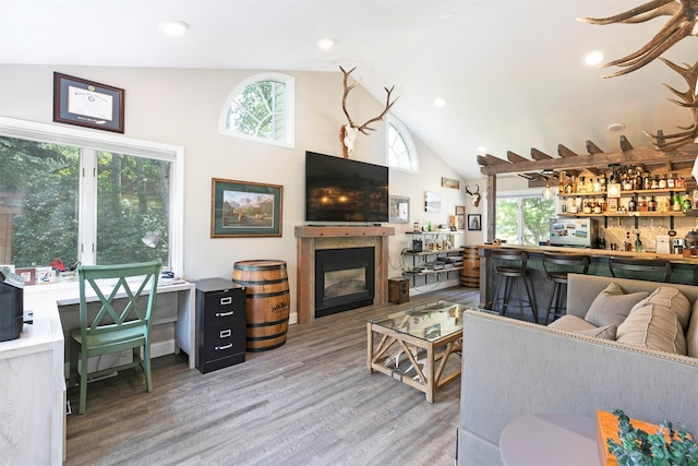 108 Apple House Ln, Missoula, MT 59802 - living room featuring a dry bar, a glass covered fireplace, wood finished floors, high vaulted ceiling, and recessed lighting