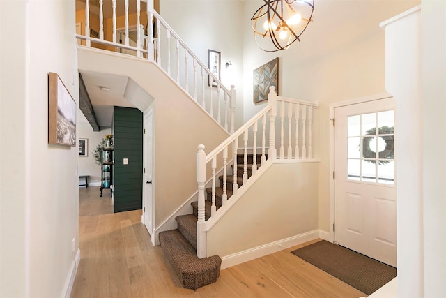 108 Apple House Ln, Missoula, MT 59802 - foyer with a towering ceiling, wood finished floors, stairs, and a chandelier