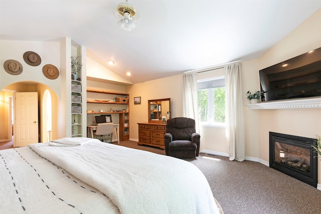 108 Apple House Ln, Missoula, MT 59802 - bedroom with carpet flooring, lofted ceiling, arched walkways, a glass covered fireplace, and recessed lighting