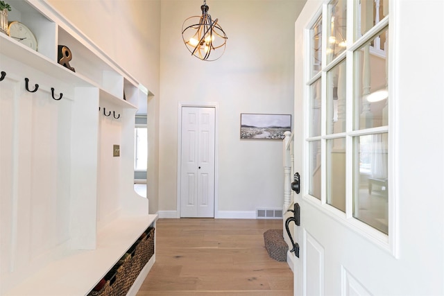 108 Apple House Ln, Missoula, MT 59802 - mudroom with light wood-style floors and a chandelier