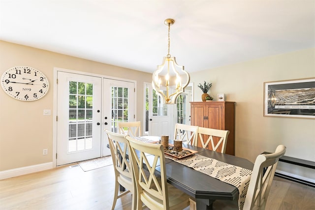 108 Apple House Ln, Missoula, MT 59802 - dining room featuring light wood-style flooring, french doors, and a chandelier