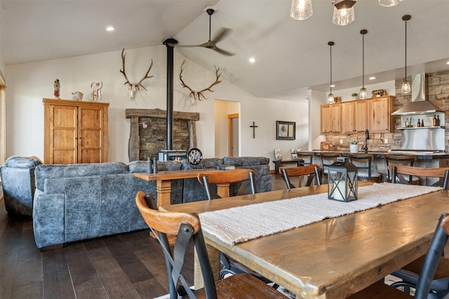 559 Stage Springs Ln, Stevensville, MT 59870 - dining room with a wood stove, dark wood-type flooring, vaulted ceiling, and recessed lighting