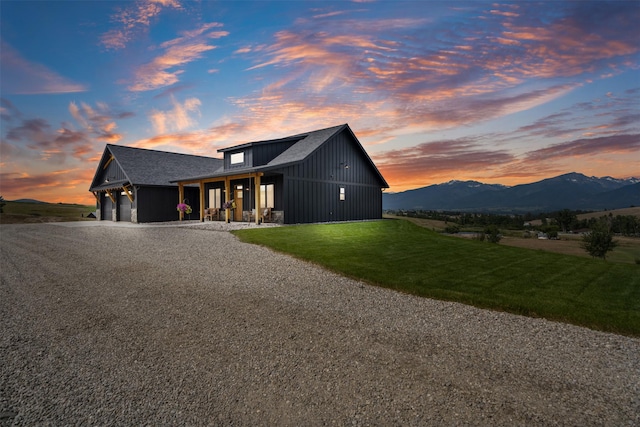 559 Stage Springs Ln, Stevensville, MT 59870 - modern farmhouse style home with gravel driveway, a garage, a lawn, a mountain view, and a porch