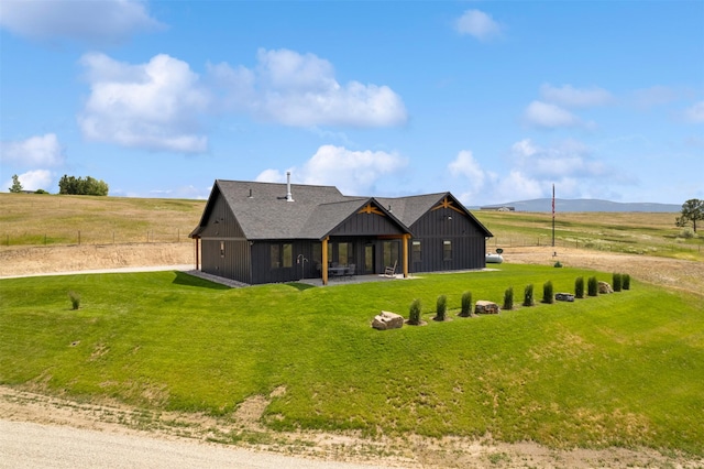 559 Stage Springs Ln, Stevensville, MT 59870 - back of property featuring dirt driveway, a lawn, and a patio