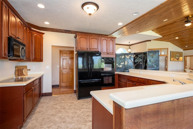 46452 Stagecoach Trl, Ronan, MT 59864 - kitchen featuring black appliances, recessed lighting, light countertops, brown cabinetry, and lofted ceiling