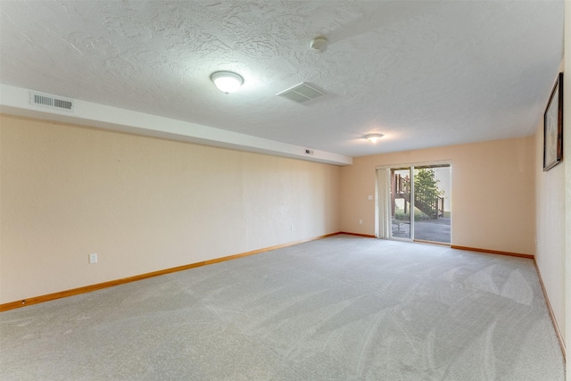 46452 Stagecoach Trl, Ronan, MT 59864 - spare room with light colored carpet, a textured ceiling, and a smoke detector