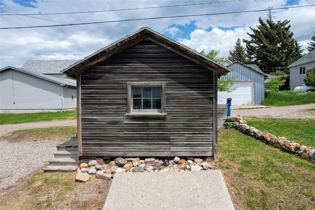 102 E Chilton St, White Sulphur Springs, MT 59645 - view of property exterior with an outdoor structure and a garage