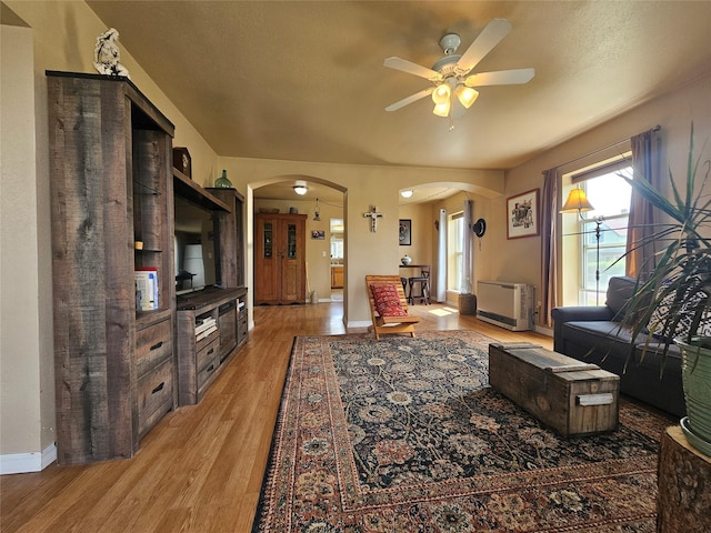 102 E Chilton St, White Sulphur Springs, MT 59645 - living room with arched walkways, a ceiling fan, light wood-style floors, and plenty of natural light