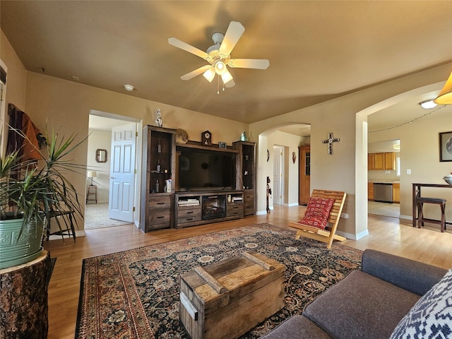 102 E Chilton St, White Sulphur Springs, MT 59645 - living area featuring arched walkways, wood finished floors, and ceiling fan