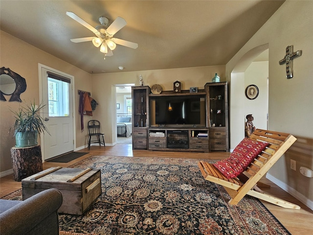 102 E Chilton St, White Sulphur Springs, MT 59645 - living room featuring a ceiling fan, arched walkways, and wood finished floors
