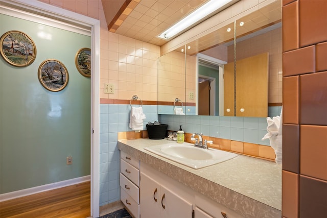 209 Spruce St, Anaconda, MT 59711 - bathroom featuring vanity, tile walls, wood finished floors, and tasteful backsplash