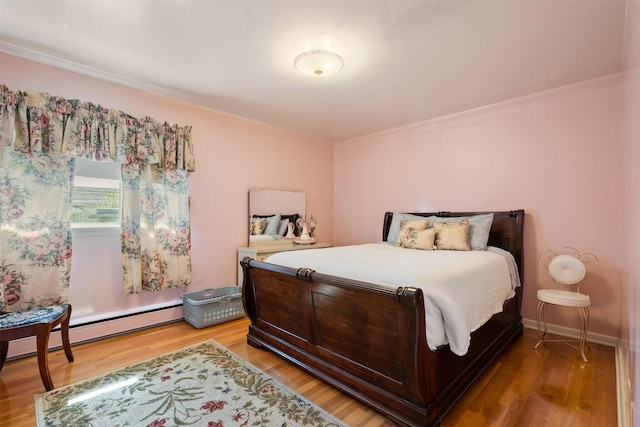 209 Spruce St, Anaconda, MT 59711 - bedroom featuring wood finished floors, ornamental molding, and baseboard heating