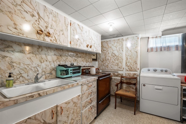 209 Spruce St, Anaconda, MT 59711 - kitchen featuring washer / clothes dryer, black range with electric cooktop, and light countertops