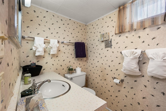 209 Spruce St, Anaconda, MT 59711 - bathroom with ornamental molding, wallpapered walls, and vanity