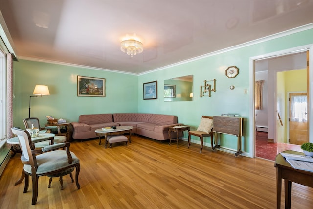209 Spruce St, Anaconda, MT 59711 - living area featuring light wood-type flooring, a baseboard heating unit, crown molding, and a chandelier