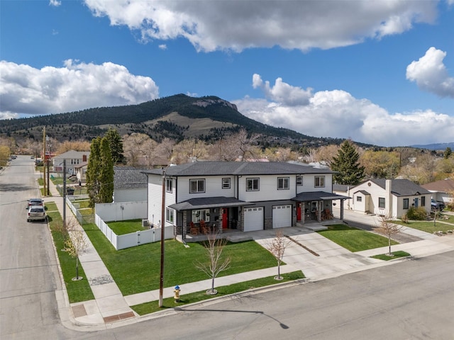 605-607 Leslie Ave, Helena, MT 59601 - multi unit property with an attached garage, concrete driveway, a mountain view, a porch, and a residential view