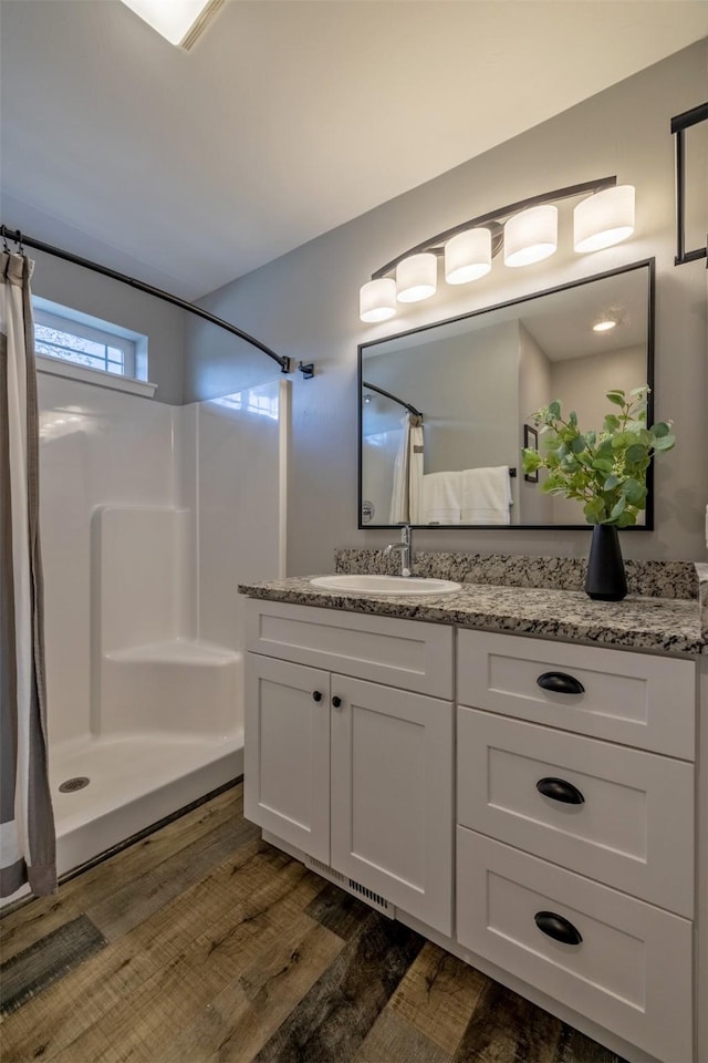 605-607 Leslie Ave, Helena, MT 59601 - bathroom with wood finished floors, curtained shower, and vanity