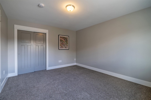 605-607 Leslie Ave, Helena, MT 59601 - unfurnished bedroom featuring dark carpet and a closet