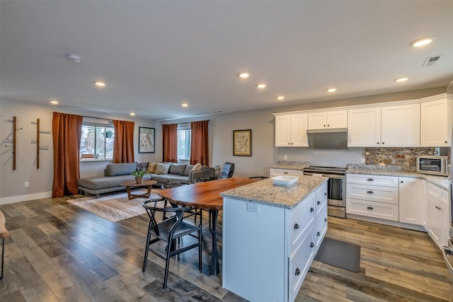 605-607 Leslie Ave, Helena, MT 59601 - kitchen with stainless steel appliances, a kitchen island, open floor plan, white cabinetry, and recessed lighting