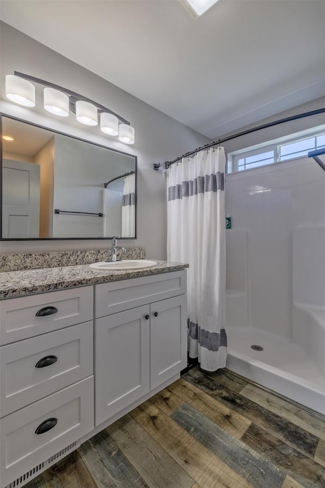 605-607 Leslie Ave, Helena, MT 59601 - bathroom with wood finished floors, vanity, and a shower with curtain
