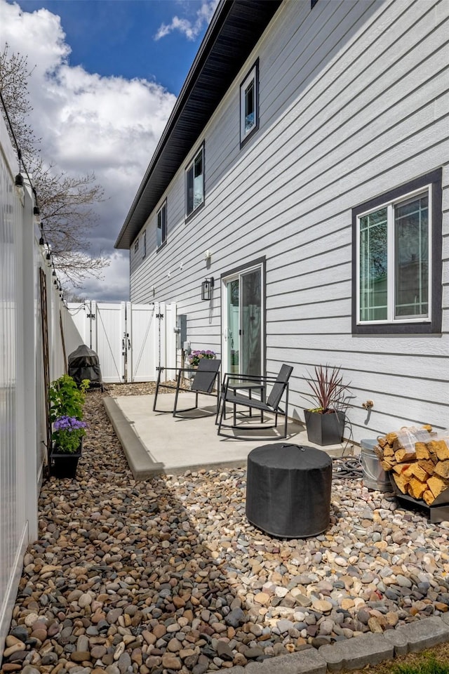 605-607 Leslie Ave, Helena, MT 59601 - back of property with a gate, a patio area, and a fenced backyard