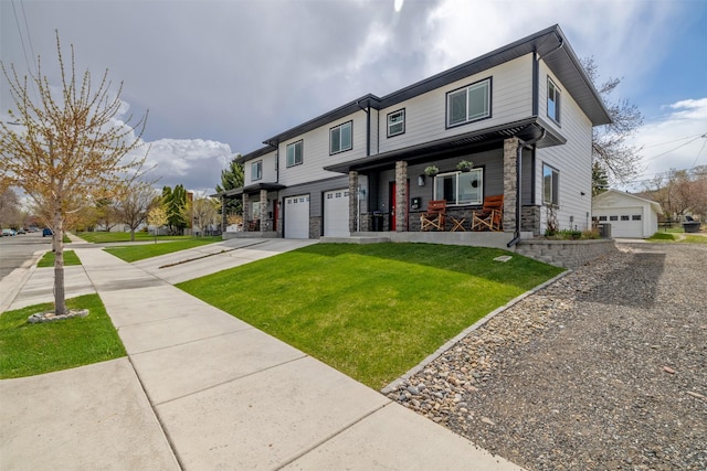 605-607 Leslie Ave, Helena, MT 59601 - view of front facade featuring covered porch, stone siding, driveway, and a front yard
