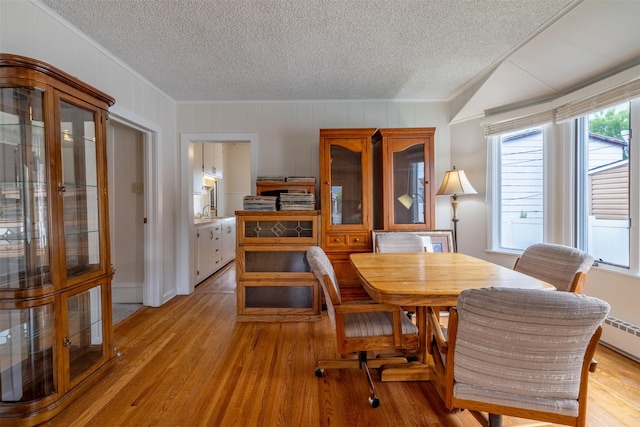 1414 Boulder Ave, Helena, MT 59601 - dining space featuring a textured ceiling, ornamental molding, and light wood-style floors