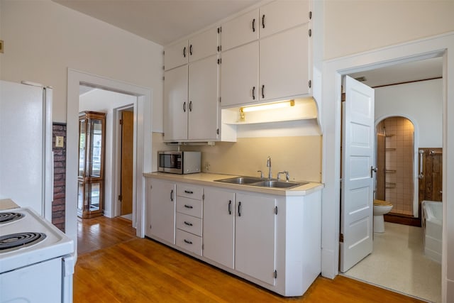 1414 Boulder Ave, Helena, MT 59601 - kitchen with white appliances, light wood finished floors, white cabinets, and light countertops