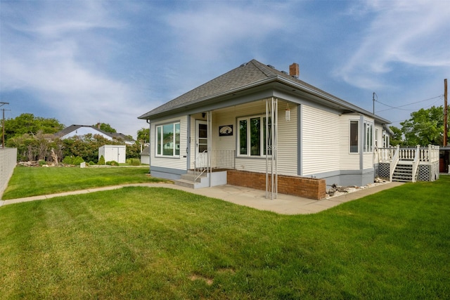 1414 Boulder Ave, Helena, MT 59601 - view of front of property featuring a chimney, a front yard, a deck, and roof with shingles