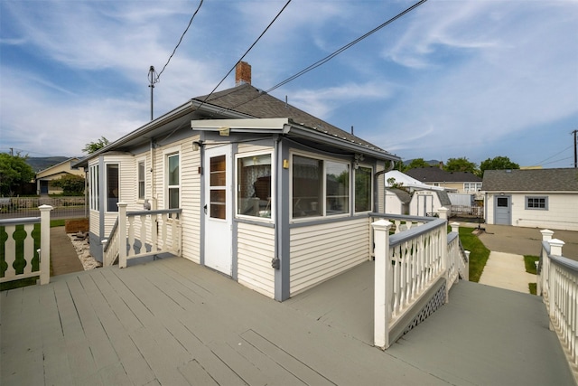 1414 Boulder Ave, Helena, MT 59601 - view of side of property with a deck, a chimney, and a shed
