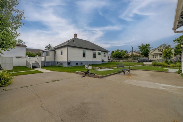 1414 Boulder Ave, Helena, MT 59601 - view of side of property featuring a patio, a chimney, and roof with shingles