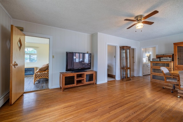 1414 Boulder Ave, Helena, MT 59601 - living area with a textured ceiling, light wood-style floors, ceiling fan, and crown molding