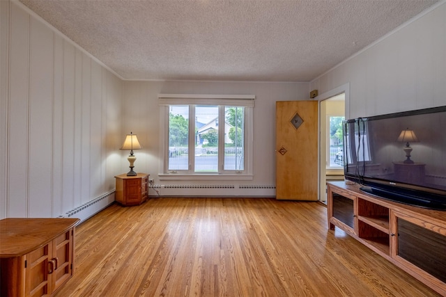 1414 Boulder Ave, Helena, MT 59601 - living room with a baseboard radiator, a textured ceiling, baseboard heating, light wood-type flooring, and ornamental molding