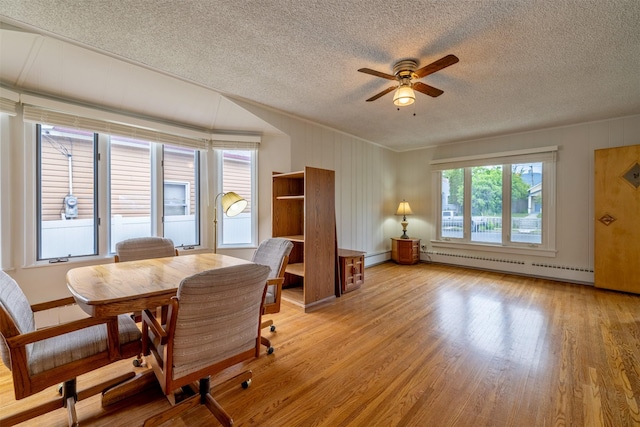 1414 Boulder Ave, Helena, MT 59601 - dining space featuring baseboard heating, ceiling fan, a textured ceiling, light wood-style flooring, and a baseboard heating unit