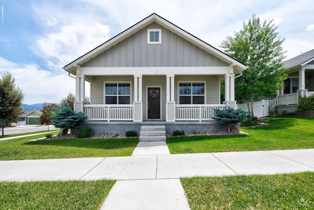 2871 Alexis Ave, Helena, MT 59601 - view of front facade featuring board and batten siding, covered porch, and a front yard