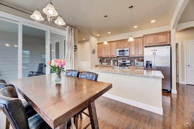 2871 Alexis Ave, Helena, MT 59601 - dining area featuring dark wood-style flooring, arched walkways, and recessed lighting
