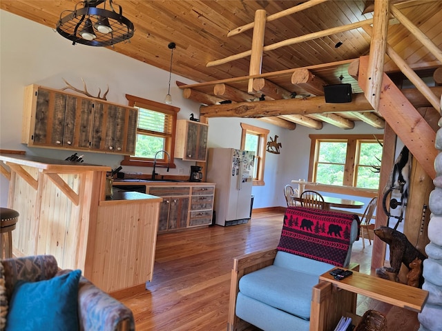 670GUSCREEK Gus Creek Rd, Yaak, MT 59935 - kitchen with freestanding refrigerator, wood ceiling, plenty of natural light, wood finished floors, and decorative light fixtures