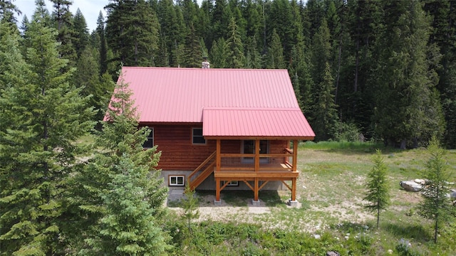670GUSCREEK Gus Creek Rd, Yaak, MT 59935 - rear view of property with a wooded view, a metal roof, and a deck