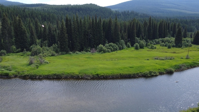 670GUSCREEK Gus Creek Rd, Yaak, MT 59935 - mountain view featuring a nearby body of water and a heavily wooded area
