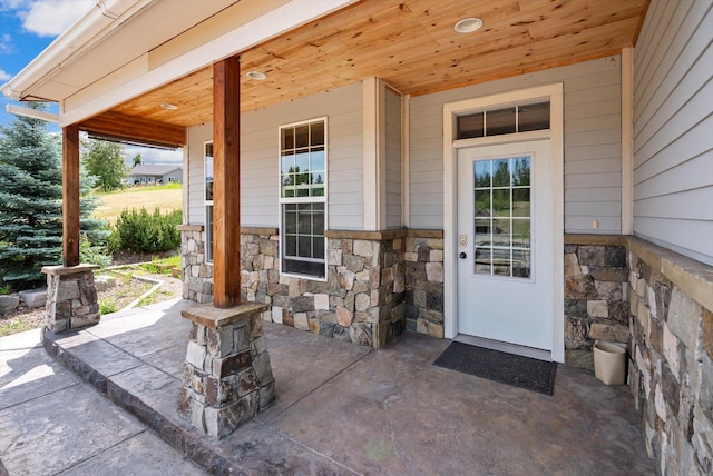 54 Bluebird Dr, Kalispell, MT 59901 - doorway to property featuring stone siding and a porch