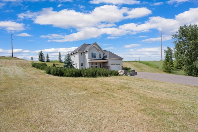 54 Bluebird Dr, Kalispell, MT 59901 - view of property exterior with driveway, an attached garage, and a yard