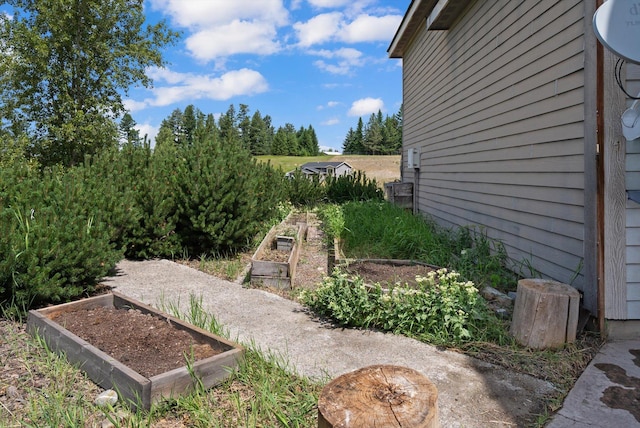 54 Bluebird Dr, Kalispell, MT 59901 - view of yard featuring a vegetable garden