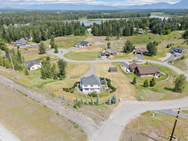 54 Bluebird Dr, Kalispell, MT 59901 - aerial view of property and surrounding area with a heavily wooded area and a large body of water