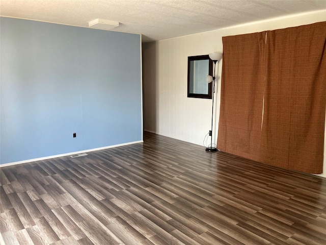 412 N Surrey St, Missoula, MT 59808 - spare room featuring dark wood finished floors and a textured ceiling