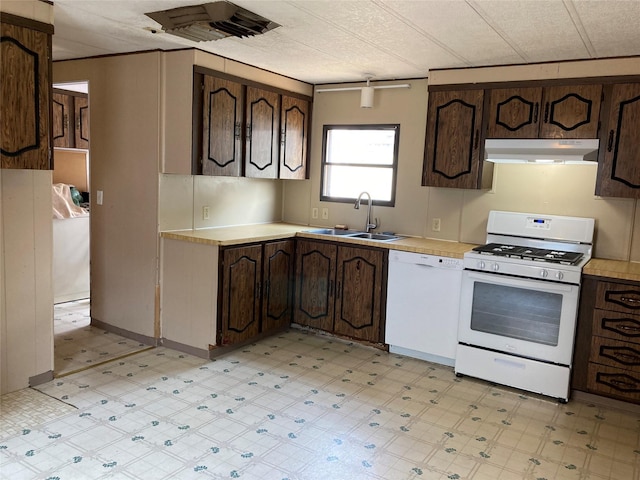 412 N Surrey St, Missoula, MT 59808 - kitchen featuring white appliances, under cabinet range hood, light countertops, light floors, and dark brown cabinetry